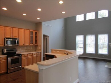 Kitchen with maple cabinets and open to the living