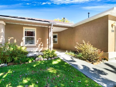 Doorway to property featuring stucco siding and a yard