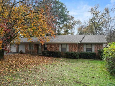 Ranch-style house featuring a garage, brick siding