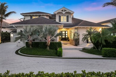 View of front of house featuring stucco siding, a tile roof, and decorative driveway