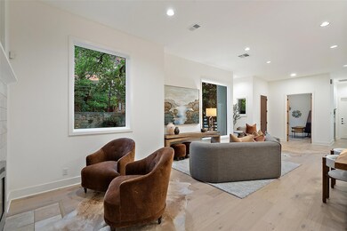 Living room featuring visible vents, a healthy am