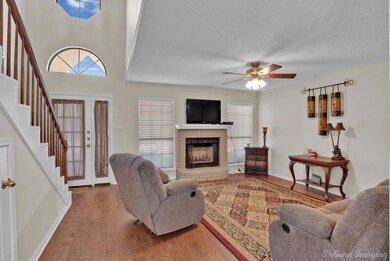 Living room with wood-type flooring, a fireplace, 