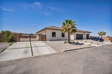 Single story home with driveway, a gate, stucco si