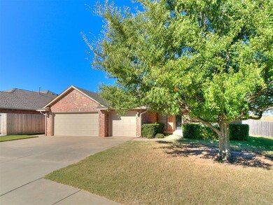 Obstructed view of property featuring driveway, a garage, and brick siding