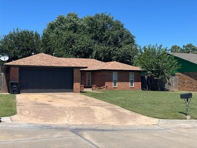 Ranch-style home featuring a garage and a front ya