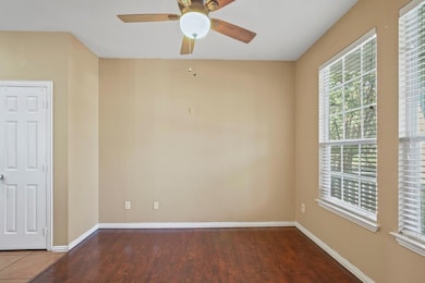 Unfurnished room featuring ceiling fan, baseboards