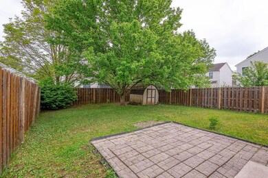 Fenced in backyard with paver patio.
