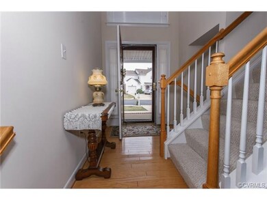Welcoming 2-story foyer with wood floors.