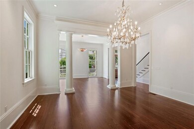 Formal dining room with columns opens to formal li