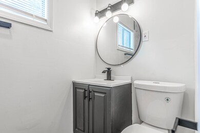 Half bathroom featuring toilet and vanity