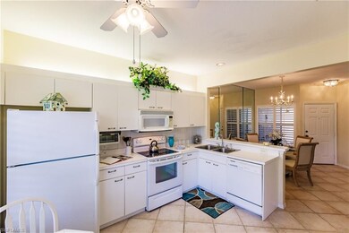 Light and bright kitchen has tile flooring and lar