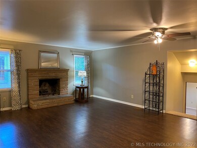 Living room with wood burning fireplace. Original