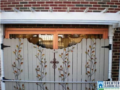 Lower level has double doors with pergola and deco