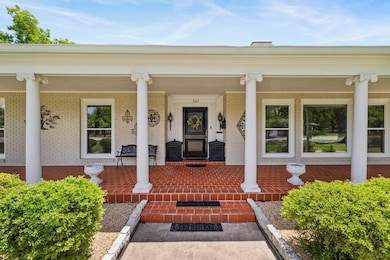Entrance to property featuring covered porch and 