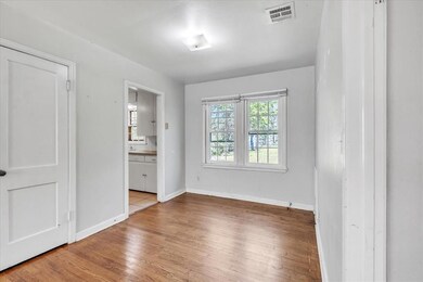 Unfurnished bedroom with connected bathroom and li
