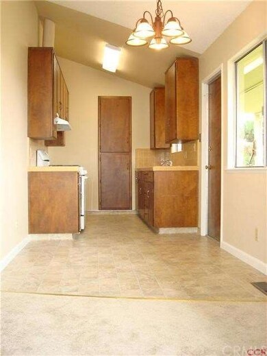 Open to the living room are the dining and kitchen