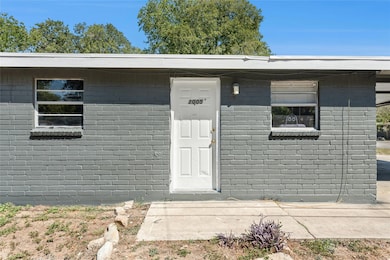 View of exterior entry featuring concrete block siding