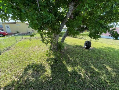 Large shade tree and fenced in yard.