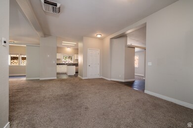 Unfurnished living room featuring healthy amount of natural light and carpet floors