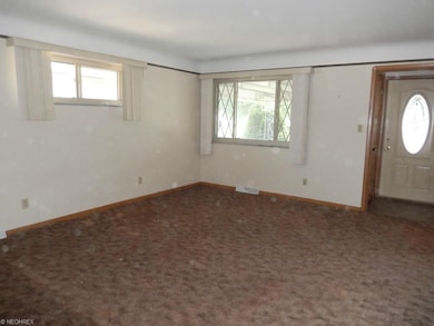Living Room with hardwood under carpet.
