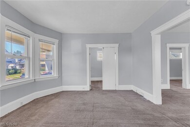 Empty room featuring carpet flooring and a wealth of natural light