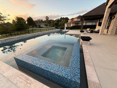 The glistening heated 1200sf custom pool features 25-yard lap lanes as well as an 8x7 spa, complete with an AquaCal water chiller for year-round comfort and enjoyment. This serene waterfront backyard retreat is complemented by additional greenspace, perfect for relaxation or outdoor entertaining.