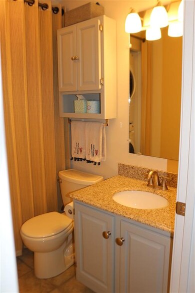 Brushed nickel knobs on gray painted cabinets.