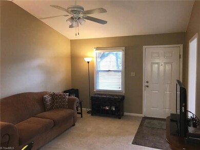Vaulted ceiling in living room with tile entrance.