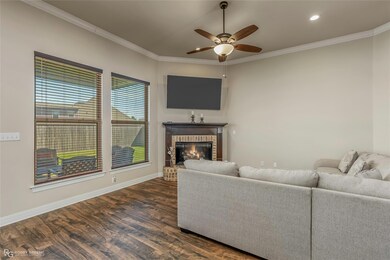 Living area with a fireplace, ornamental molding, 