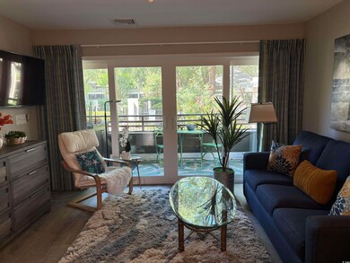 Living room featuring healthy amount of natural light and wood finished floors
