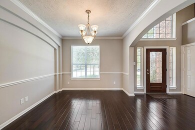 Formal dining space is to the right upon two-story entry. Upgraded engineered espresso hardwoods grace the first floor.