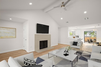 Living room featuring beam ceiling, recessed lighting, light wood finished floors, a high end fireplace, and high vaulted ceiling