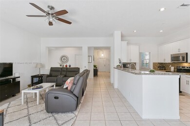 Family room & kitchen with long snack bar that sea