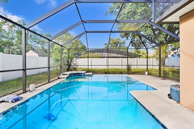View of pool with a lanai, a fenced backyard, a sunroom, and a patio area