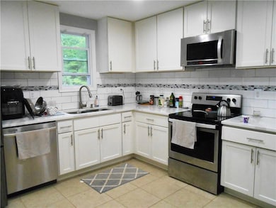 Kitchen featuring stainless steel appliances, a si