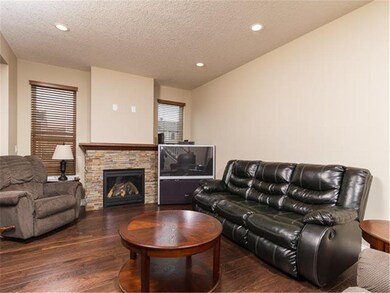 Living room with hardwood floor and gas fireplace