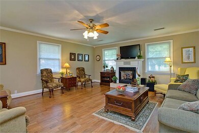 21X18 Family room with gas log fireplace, hardwood flooring, private outside entrance to carport