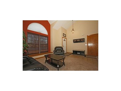 Comfortable living room with tile and carpet floor