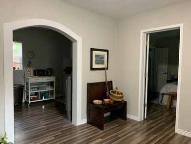 Corridor featuring arched walkways and dark wood finished floors