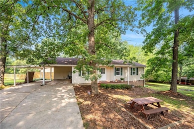 Single story home with a carport and driveway
