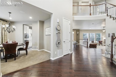 Foyer with hardwood / wood-style flooring and ceil