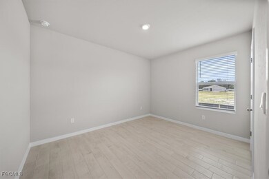 Empty room featuring light wood finished floors and recessed lighting