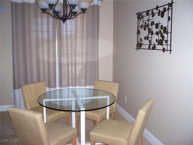 Dining area featuring a chandelier and baseboards