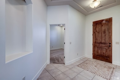 Tiled entrance foyer with baseboards