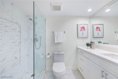 Full bath with vanity, light marble finish floors, a marble finish shower, and recessed lighting