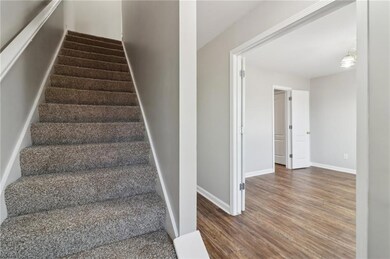 Stairway featuring baseboards and wood finished fl
