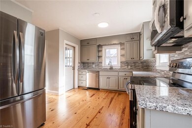 Renovated kitchen with new stainless steel appliances, granite counter tops, new cabinetry and refinished hardwood floors.