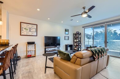 Living room with a ceiling fan and recessed lighting