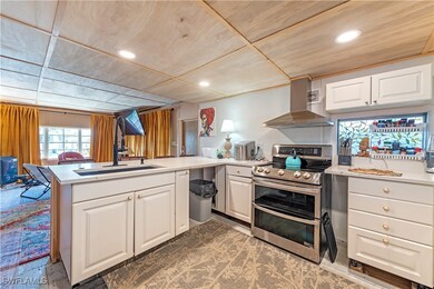 Kitchen with range with two ovens, a sink, open fl