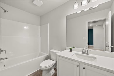 Full bathroom featuring shower / tub combination, vanity, and dark tile patterned flooring